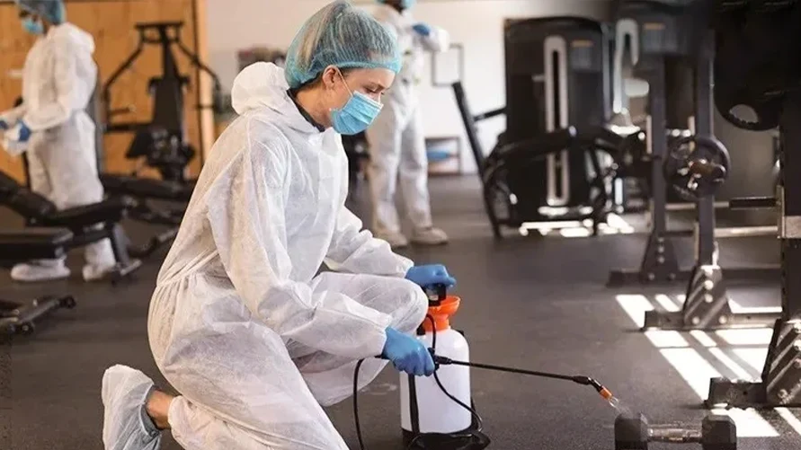 cleaning staff working in gym